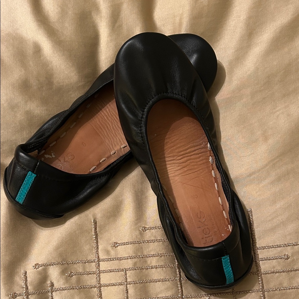 Tieks Leather Flats in Black with Teal Detail.